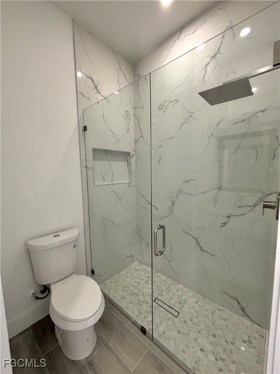 3010 45th Street Southwest Lehigh Acres, FL 33976 - Photo 16 of 29 a bathroom with a toilet and a shower