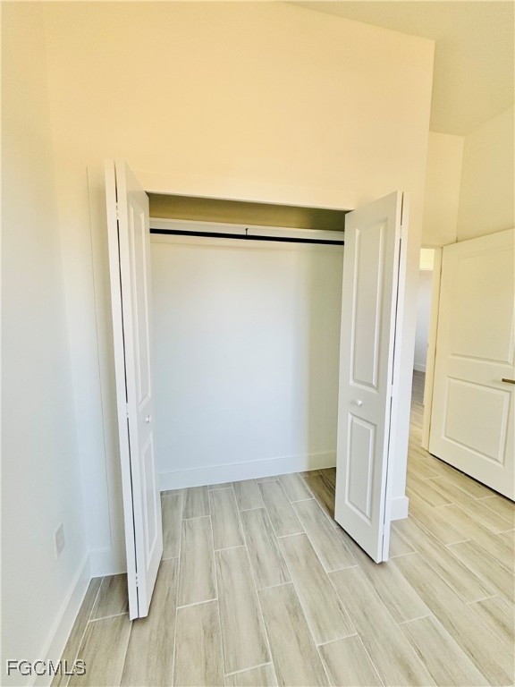 3010 45th Street Southwest Lehigh Acres, FL 33976 - Photo 17 of 29 wooden floor in an empty room