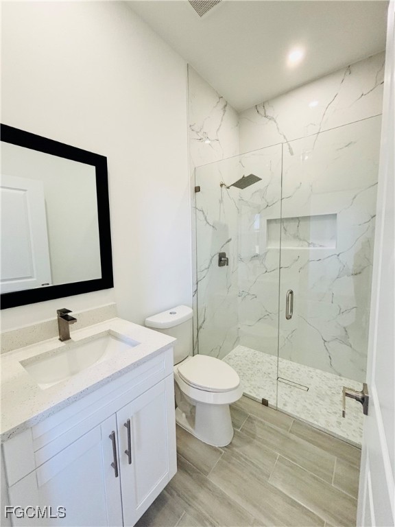 3010 45th Street Southwest Lehigh Acres, FL 33976 - Photo 20 of 29 a bathroom with a sink toilet a mirror and shower