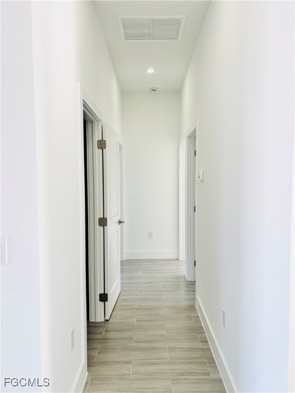 3010 45th Street Southwest Lehigh Acres, FL 33976 - Photo 22 of 29 a view of a hallway with wooden floor and staircase