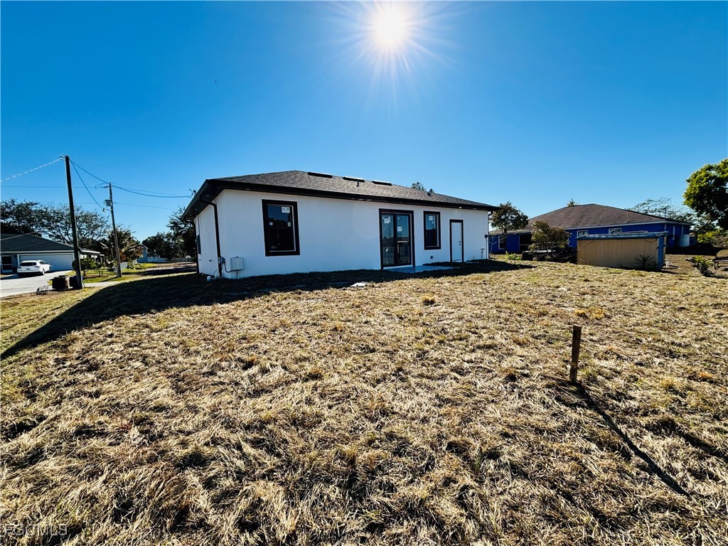 3010 45th Street Southwest Lehigh Acres, FL 33976 - Photo 26 of 29 a house with a yard