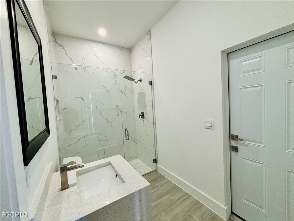 3010 45th Street Southwest Lehigh Acres, FL 33976 - Photo 4 of 29 a bathroom with a sink a toilet and shower