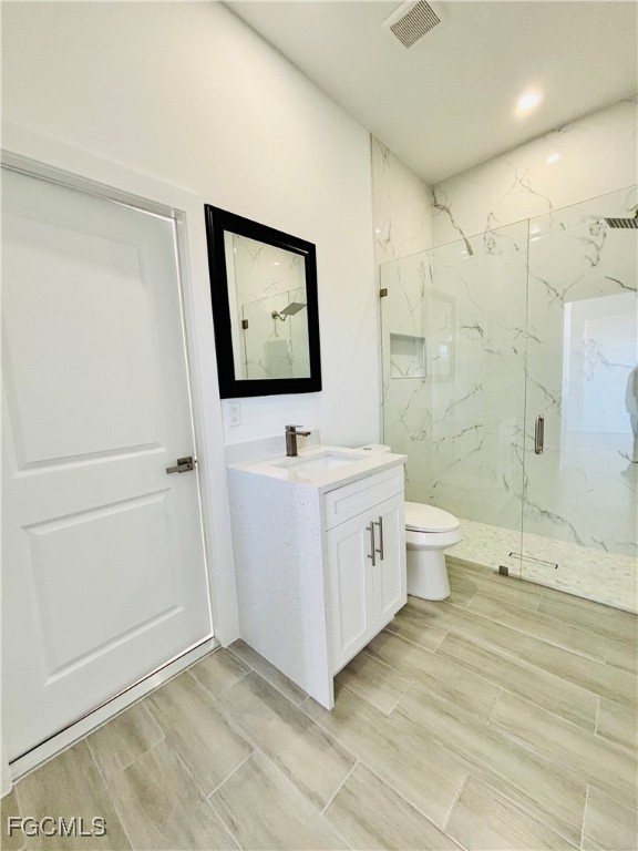 3010 45th Street Southwest Lehigh Acres, FL 33976 - Photo 5 of 29 a bathroom with a double vanity sink a toilet and shower