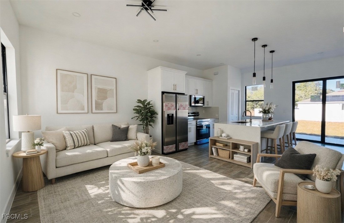 3010 45th Street Southwest Lehigh Acres, FL 33976 - Photo 7 of 29 a living room with furniture and a table