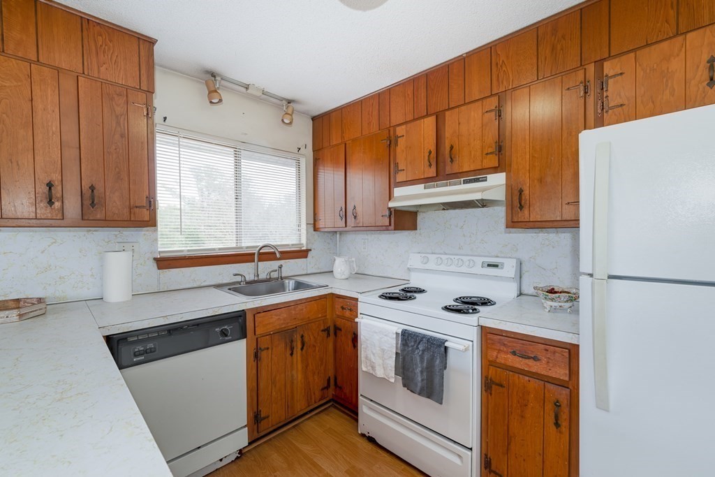 7 Susan Road, Unit 7 Buzzards Bay, MA 02532 - Photo 7 of 36 a kitchen with a sink a stove and refrigerator
