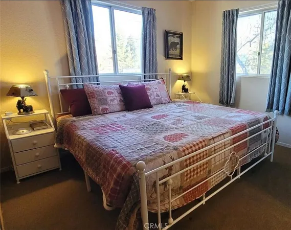 a bed sitting in a bedroom next to a window