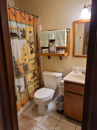 a white toilet sitting next to a bathroom sink