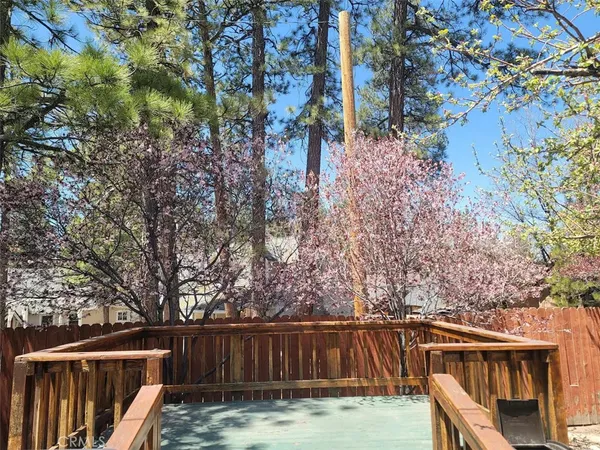 a view of a wooden fence and trees in the background