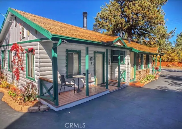 a front view of a house with outdoor seating
