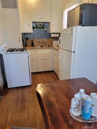 a kitchen with a sink a refrigerator and a stove