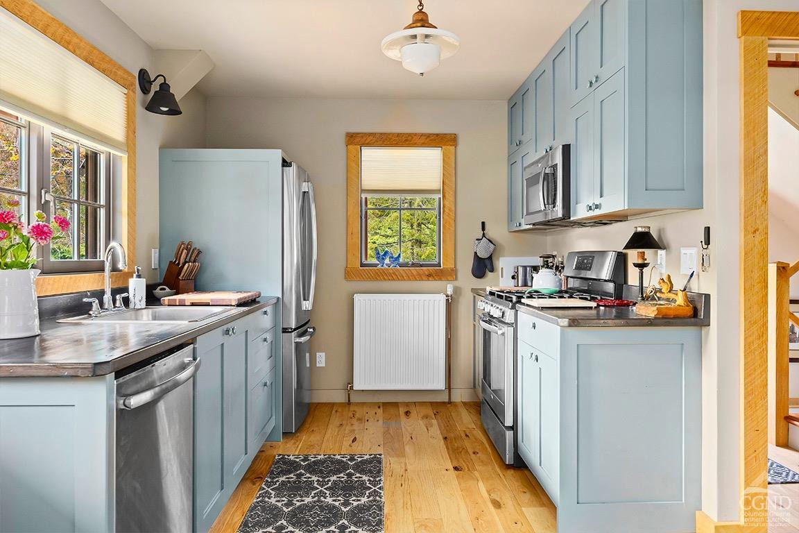 214 Fog Hill Road Austerlitz, NY 12017 - Photo 11 of 38 a kitchen with a sink stove and refrigerator