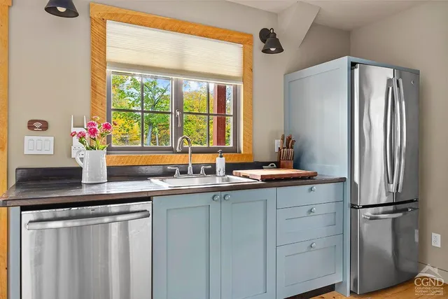 a kitchen with stainless steel appliances a sink and a refrigerator