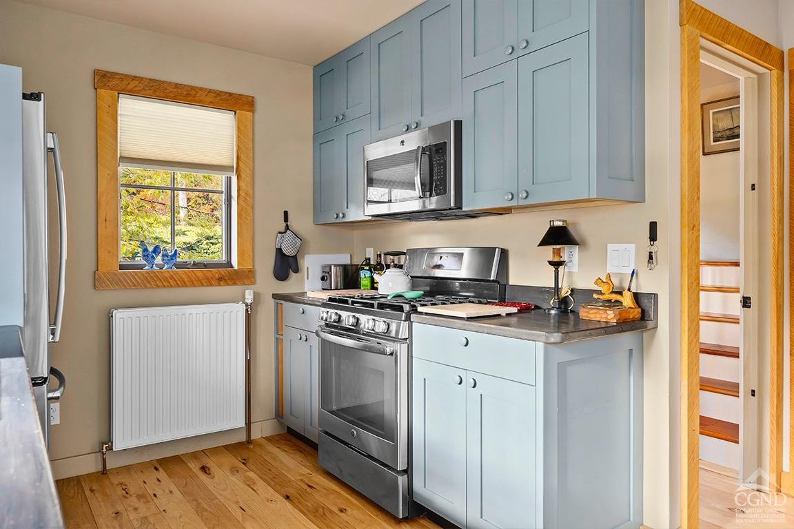 214 Fog Hill Road Austerlitz, NY 12017 - Photo 13 of 38 a kitchen with stainless steel appliances granite countertop a stove a sink and a microwave