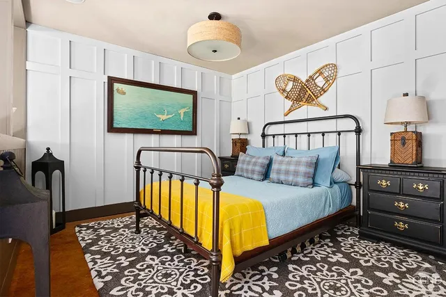 a bedroom with bed and a flat screen tv