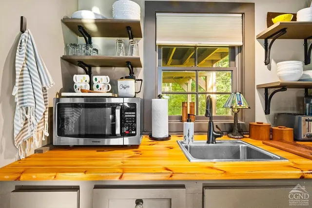 a kitchen with stainless steel appliances a stove and a microwave