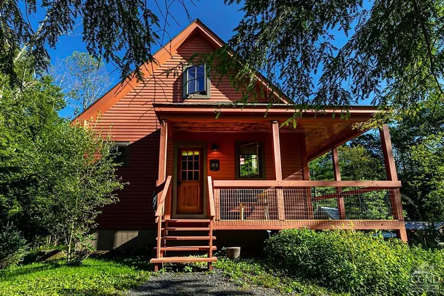 front view of a house with a tree