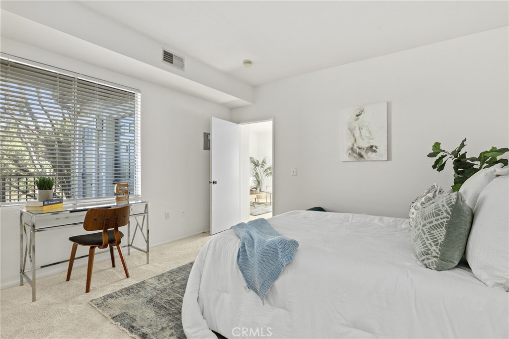 20000 Plum Canyon Road, Unit 221 Saugus, CA 91350 - Photo 11 of 30 a bedroom with a bed and a large window