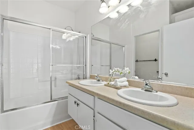 a bathroom with a double vanity sink and a mirror