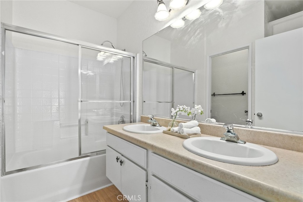 20000 Plum Canyon Road, Unit 221 Saugus, CA 91350 - Photo 13 of 30 a bathroom with a double vanity sink and a mirror