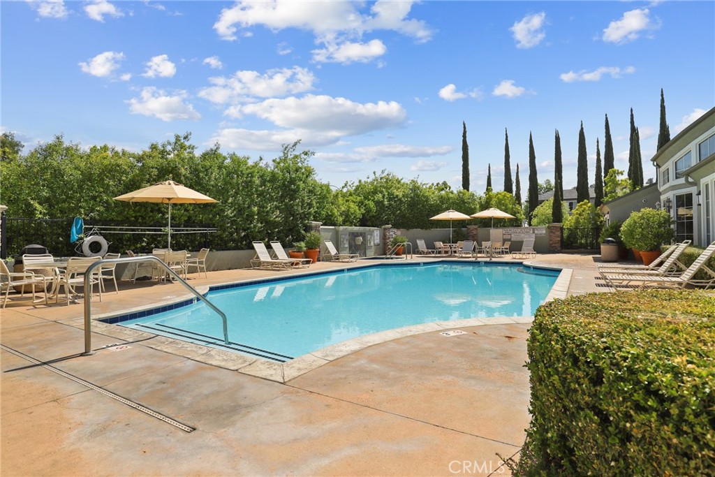 20000 Plum Canyon Road, Unit 221 Saugus, CA 91350 - Photo 23 of 30 a view of swimming pool with outdoor seating and plants