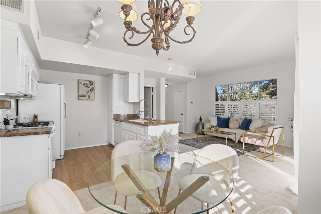 20000 Plum Canyon Road, Unit 221 Saugus, CA 91350 - Photo 5 of 30 a living room with furniture or couch and a dining table