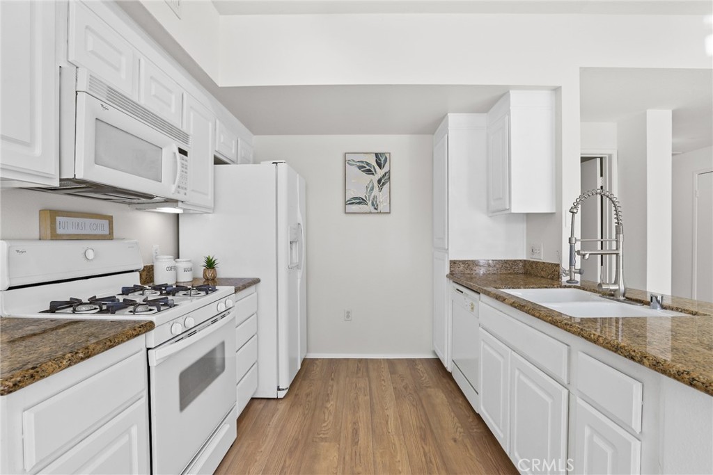 20000 Plum Canyon Road, Unit 221 Saugus, CA 91350 - Photo 6 of 30 a kitchen with stainless steel appliances granite countertop a sink stove and refrigerator