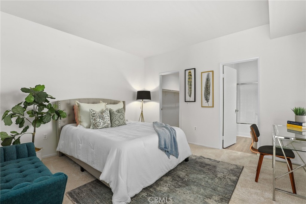 20000 Plum Canyon Road, Unit 221 Saugus, CA 91350 - Photo 10 of 30 a bedroom with a bed table and chair