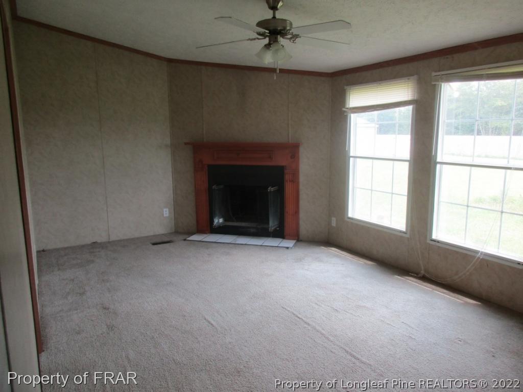 794 Wiggins Road Clinton, NC 28328 - Photo 11 of 18 an empty room with windows and fireplace