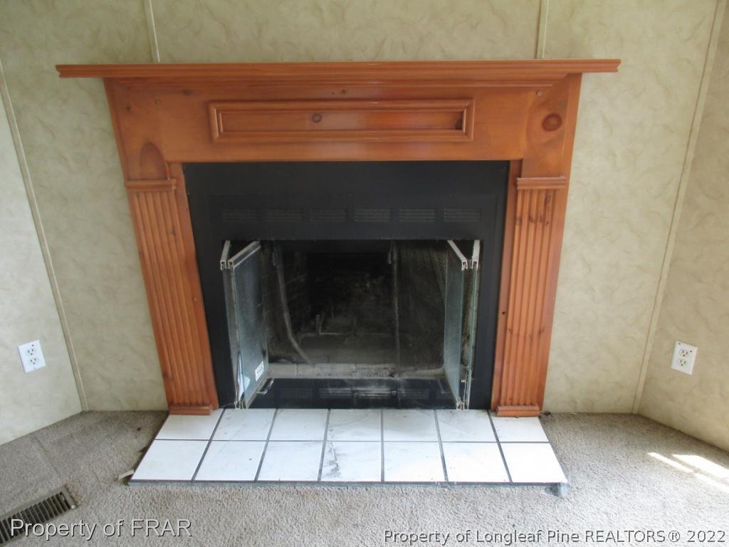 794 Wiggins Road Clinton, NC 28328 - Photo 12 of 18 a view of a fireplace in a room