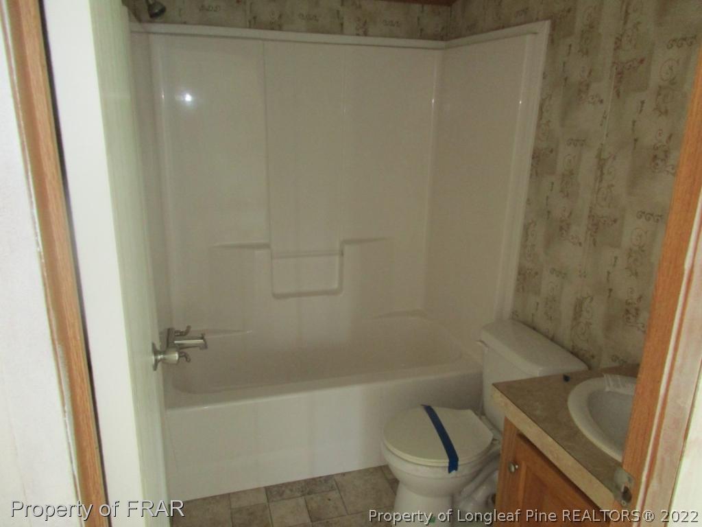 794 Wiggins Road Clinton, NC 28328 - Photo 13 of 18 a bathroom with a bathtub