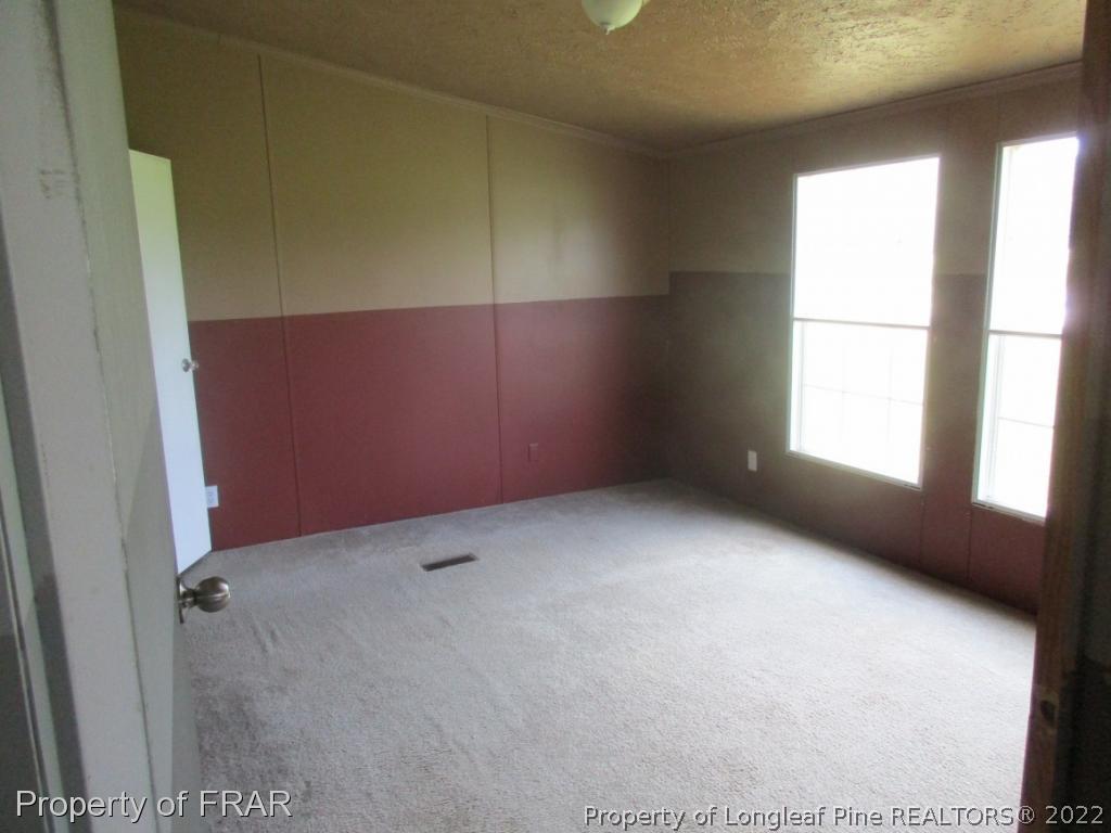 794 Wiggins Road Clinton, NC 28328 - Photo 14 of 18 an empty room with windows
