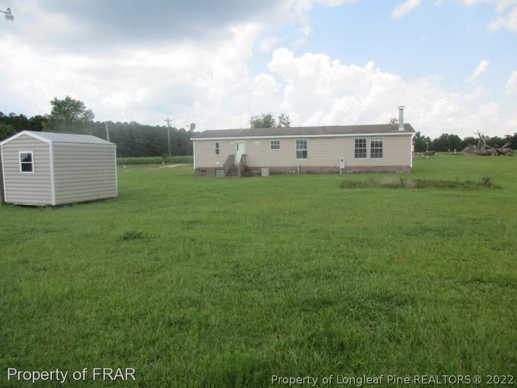 794 Wiggins Road Clinton, NC 28328 - Photo 18 of 18 a view of a house with a yard