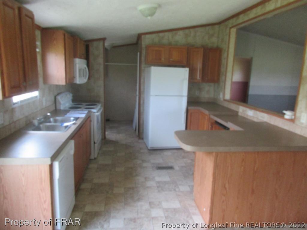 794 Wiggins Road Clinton, NC 28328 - Photo 5 of 18 a bathroom with a sink and a mirror