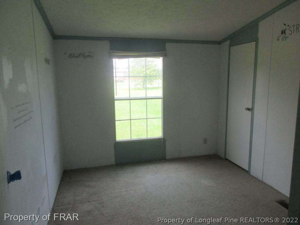 794 Wiggins Road Clinton, NC 28328 - Photo 9 of 18 an empty room with a window