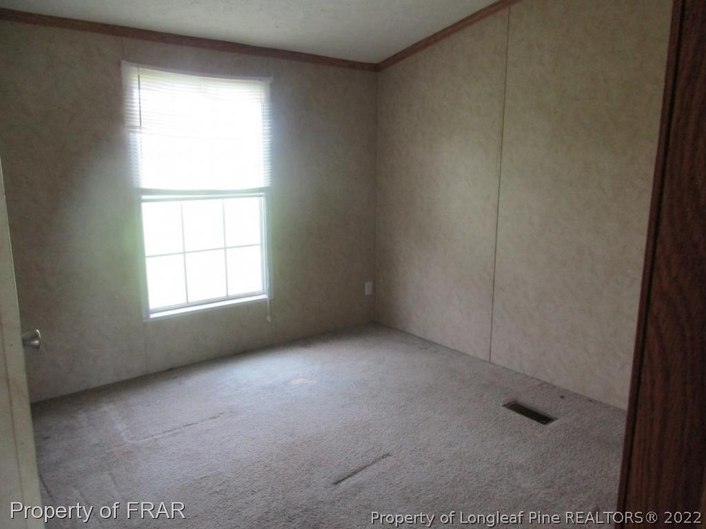 794 Wiggins Road Clinton, NC 28328 - Photo 10 of 18 an empty room with a window