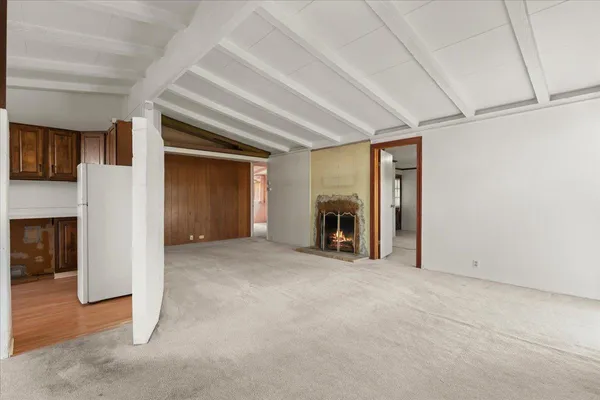 a view of empty room with a fireplace
