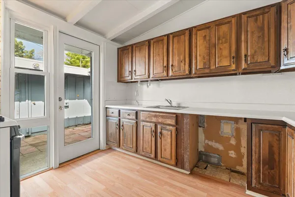 a kitchen with stainless steel appliances granite countertop a refrigerator and a sink