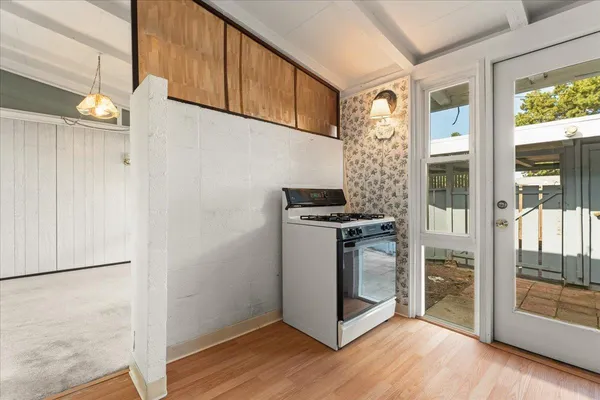 a kitchen with a refrigerator and a stove