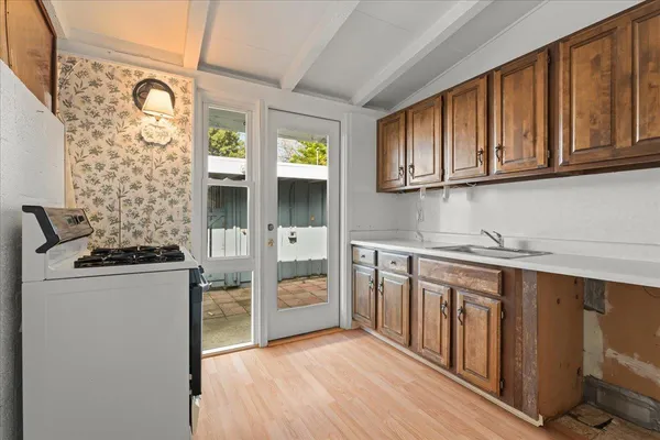 a kitchen with stainless steel appliances granite countertop a stove and a refrigerator