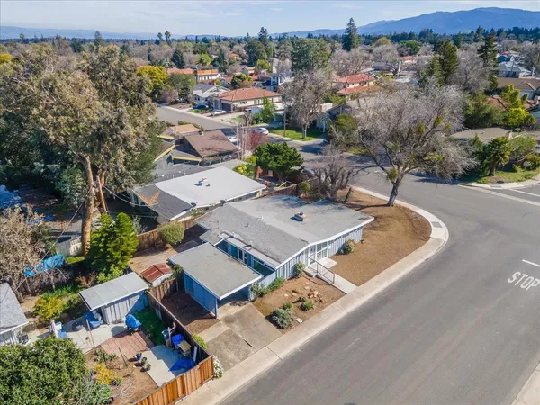 an aerial view of a house with a yard
