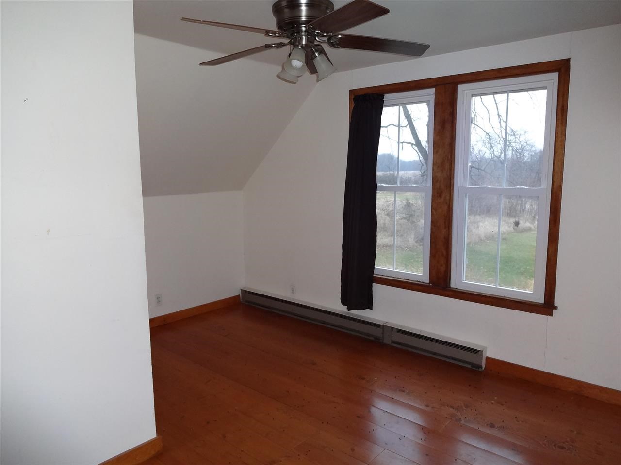 4991 South Ridge Road Oregon, IL 61061 - Photo 11 of 15 an empty room with wooden floor and windows