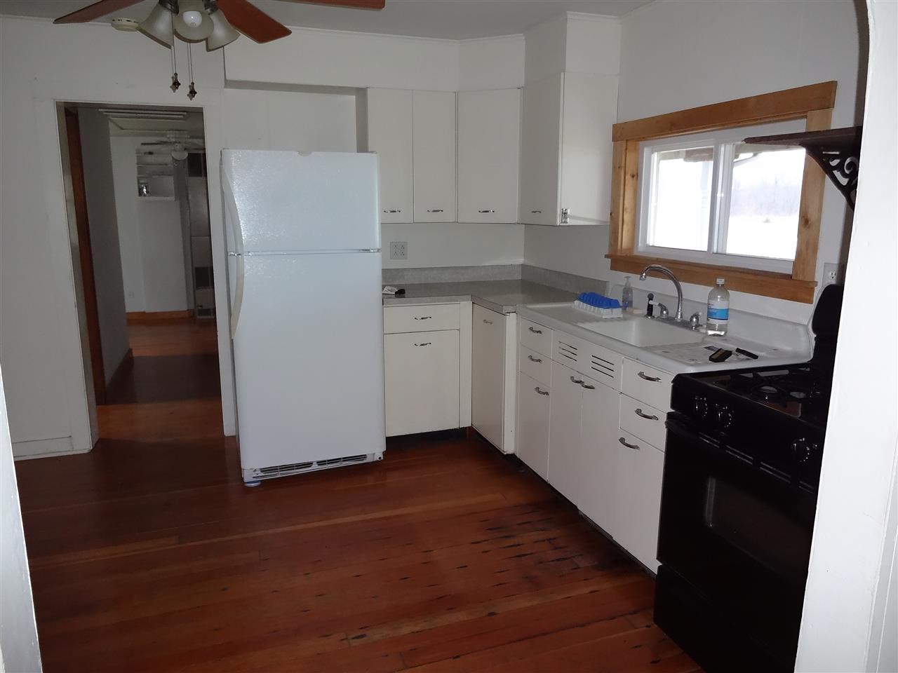 4991 South Ridge Road Oregon, IL 61061 - Photo 4 of 15 a kitchen with a refrigerator sink and cabinets
