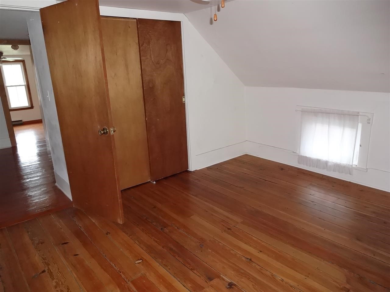 4991 South Ridge Road Oregon, IL 61061 - Photo 9 of 15 an empty room with wooden floor and windows