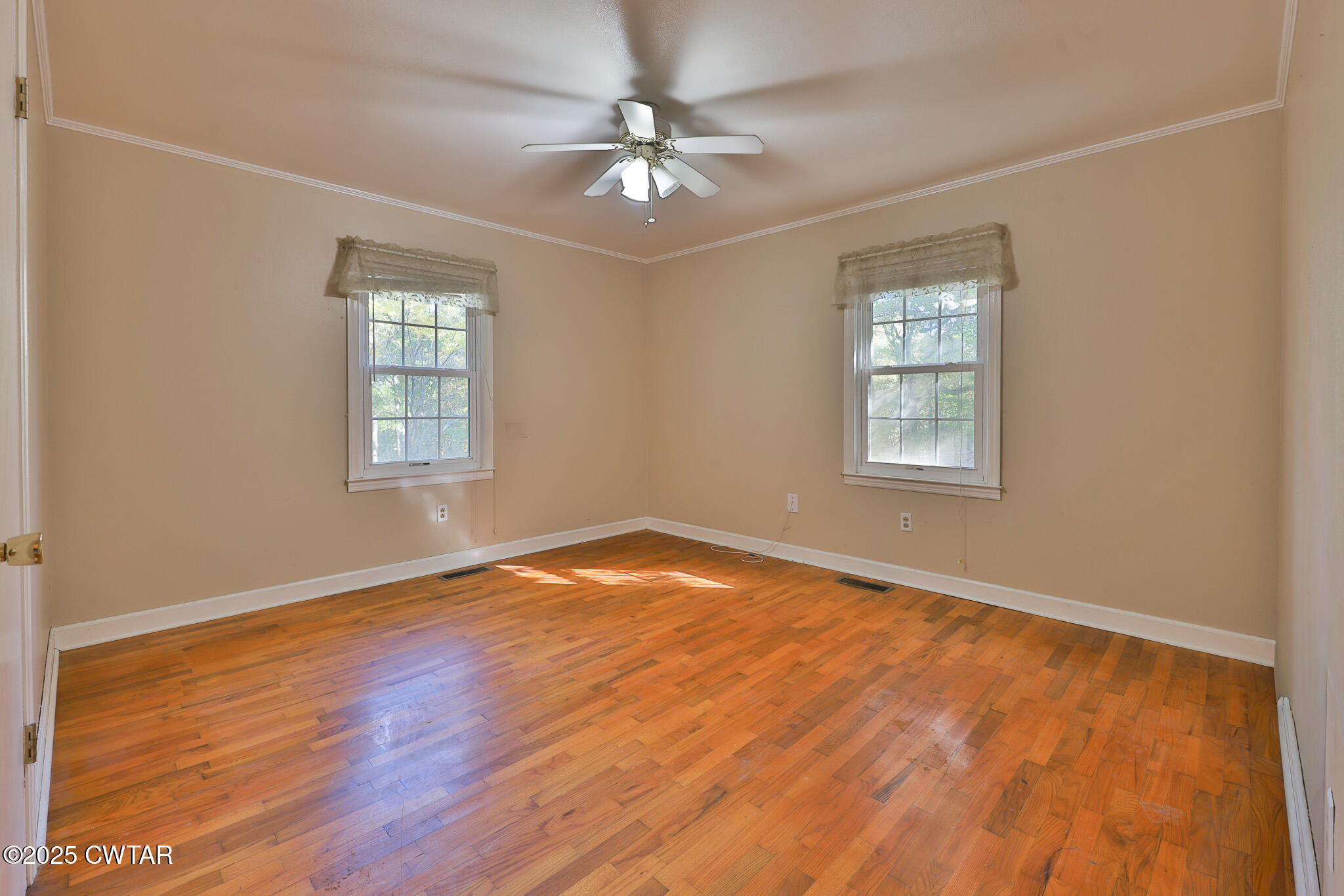 4030 Shades Bridge Road Greenfield, TN 38230 - Photo 12 of 27 a view of an empty room with a window and wooden floor
