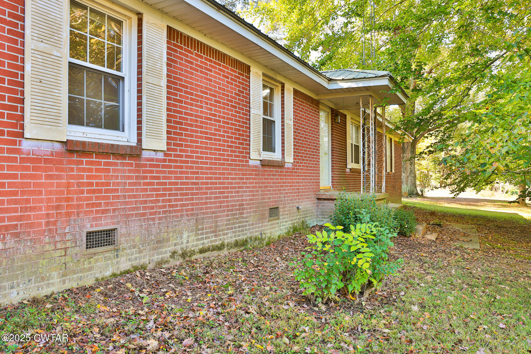 4030 Shades Bridge Road Greenfield, TN 38230 - Photo 16 of 27 a front view of a house with garden