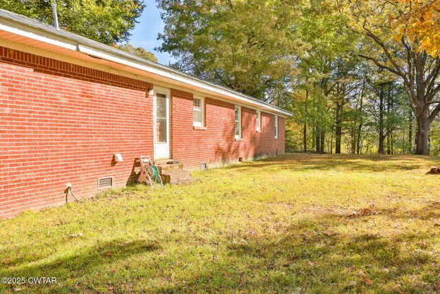 a house view with swimming pool in front of it