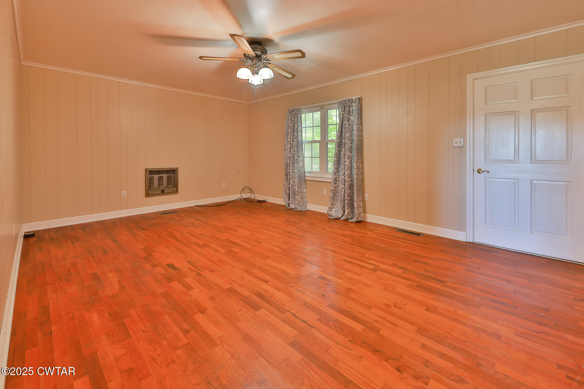 4030 Shades Bridge Road Greenfield, TN 38230 - Photo 3 of 27 an empty room with wooden floor fan and windows