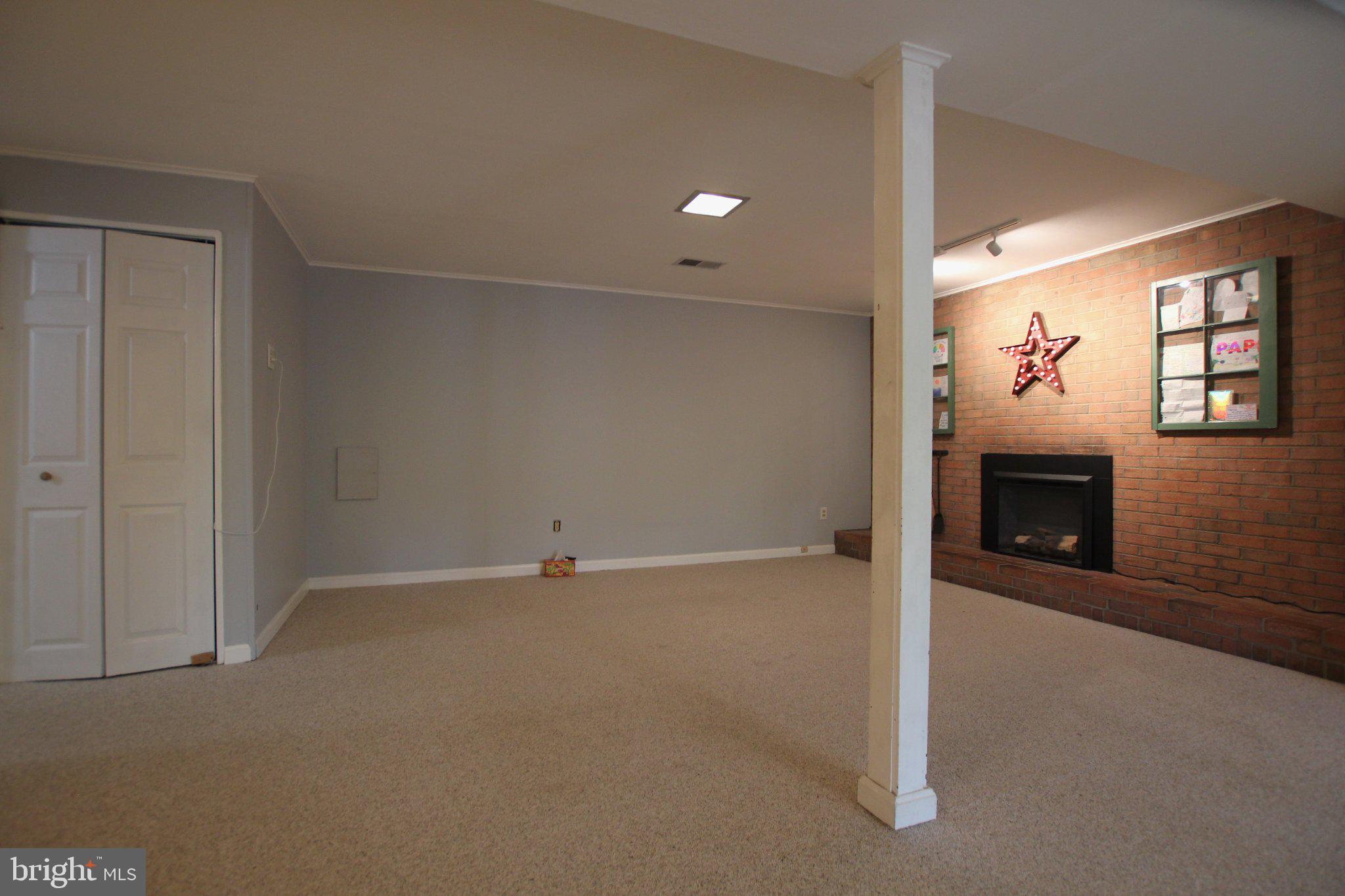 8502 Ivybridge Court Springfield, VA 22152 - Photo 24 of 31 an empty room with windows and fireplace