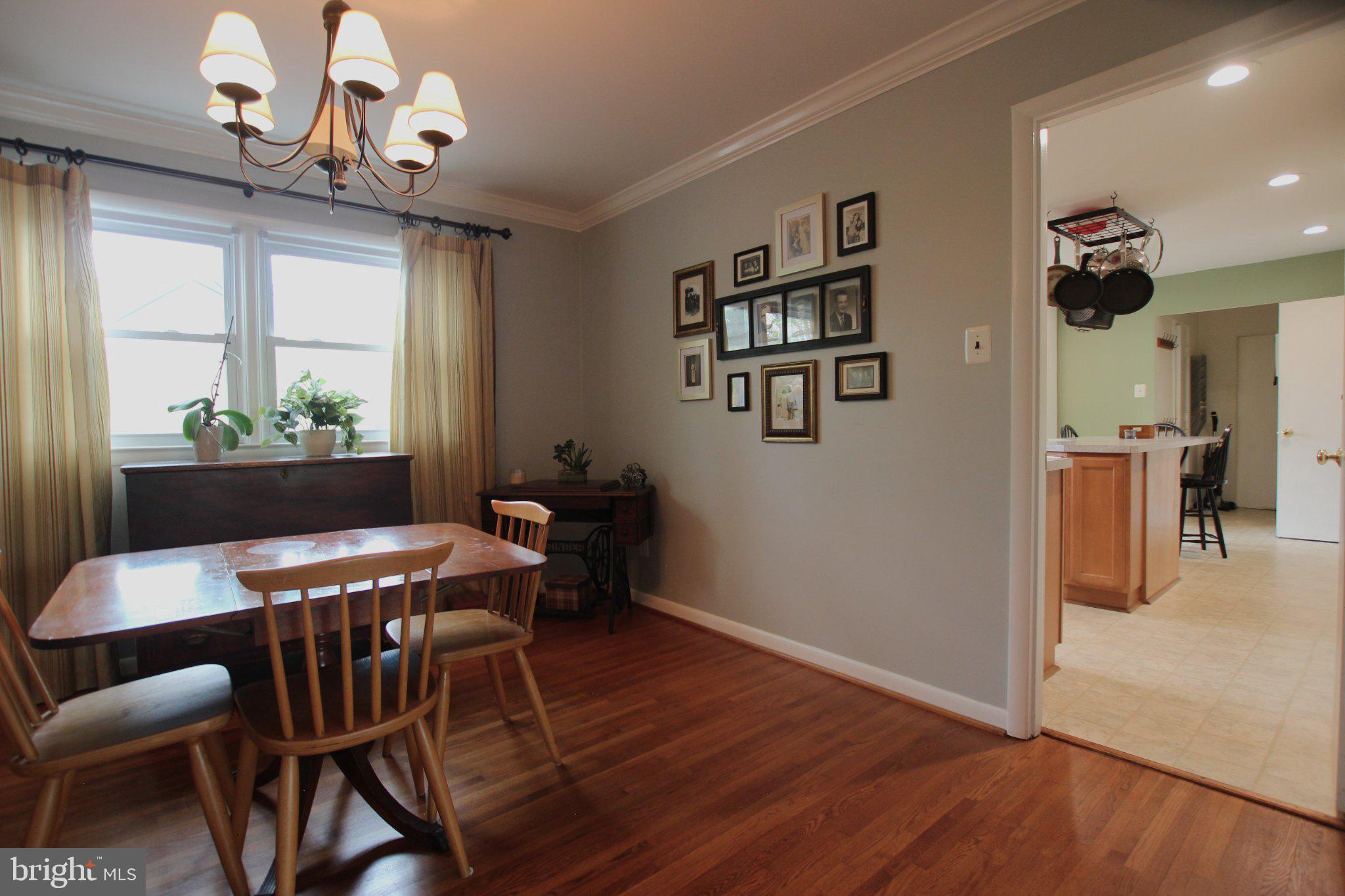 8502 Ivybridge Court Springfield, VA 22152 - Photo 6 of 31 a view of a dining room with furniture window and wooden floor
