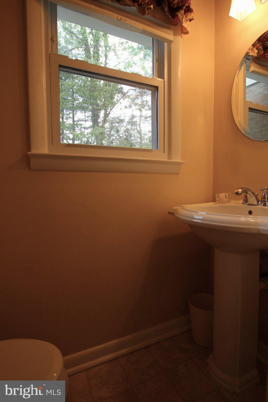 8502 Ivybridge Court Springfield, VA 22152 - Photo 8 of 31 a bathroom with a sink a toilet and a window